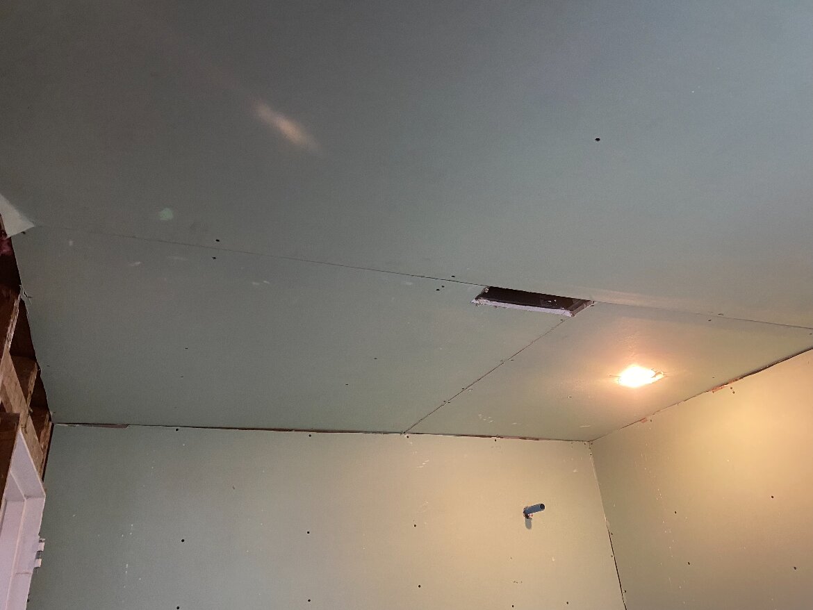 Freshly hung drywall ceiling and walls